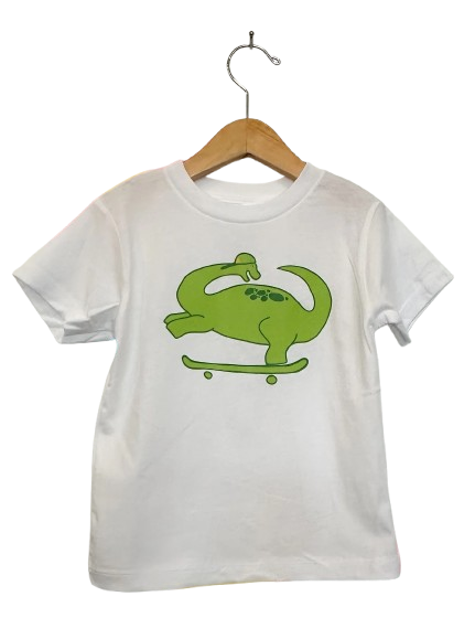 White t-shirt with a green dinosaur graphic on a wooden hanger against a white background