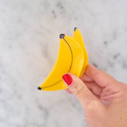 Bold statement earrings and whimsical hair claws from Bella Vita's curated accessory collection