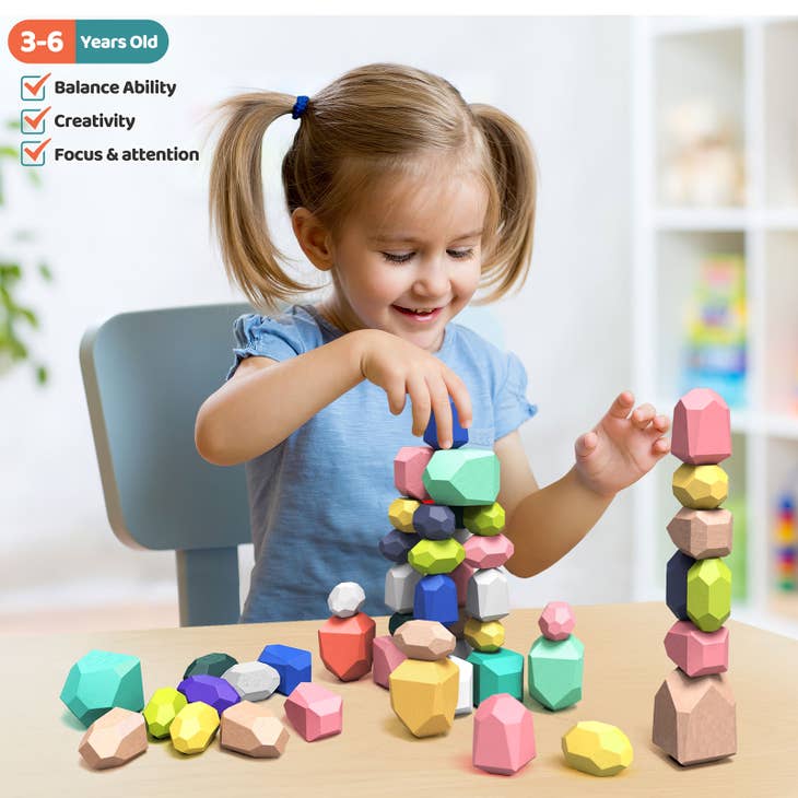 A child playing with colorful wooden blocks at a white table