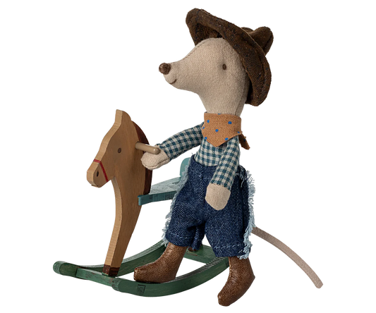 Toy mouse in cowboy outfit riding a wooden rocking horse on a white background