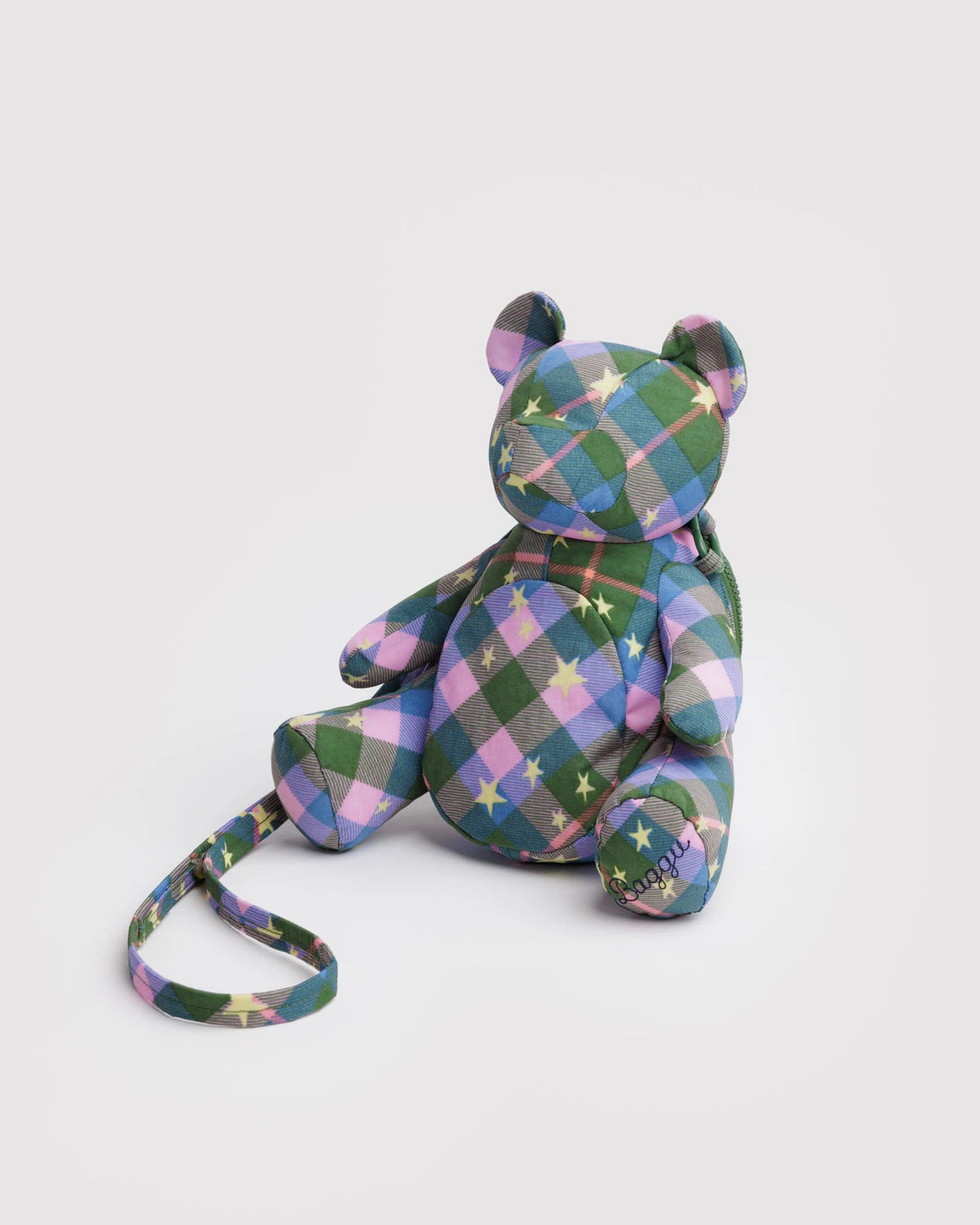 Plaid patterned teddy bear with a strap on a white background