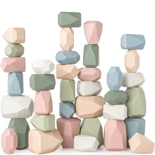 Load image into Gallery viewer, Colorful geometric toy stone blocks stacked on a white background
