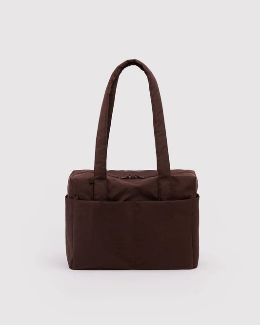 A dark brown fabric organizer tote bag with two top handles and multiple front pockets, shown against a light gray background.