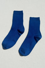 Load image into Gallery viewer, Pair of blue socks on a light gray background
