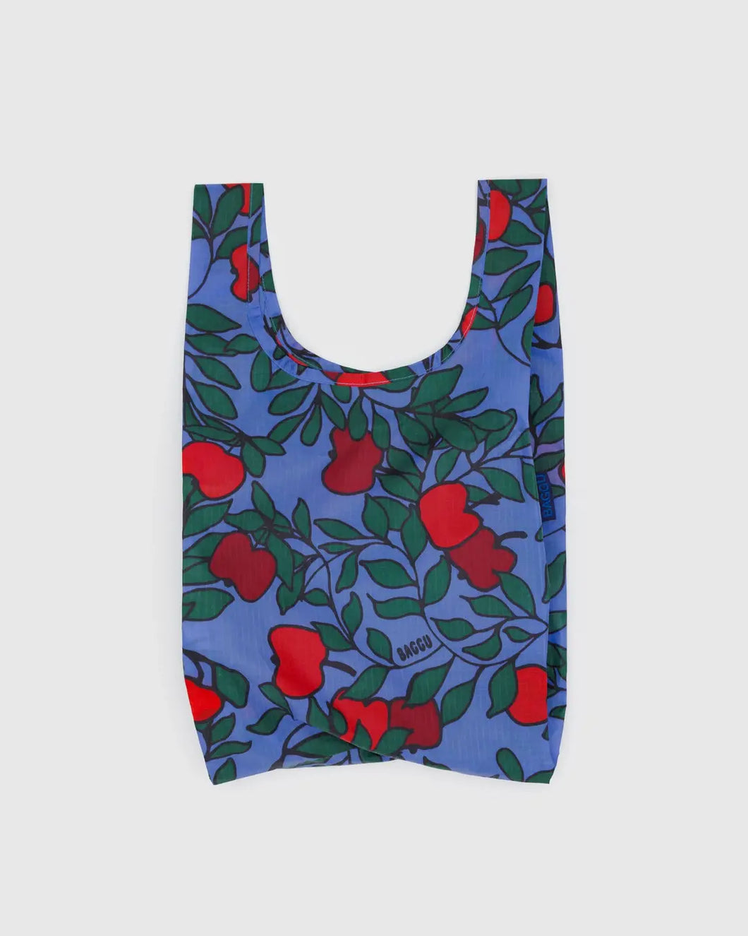 Baggu reusable bag with red apple pattern on a blue background
